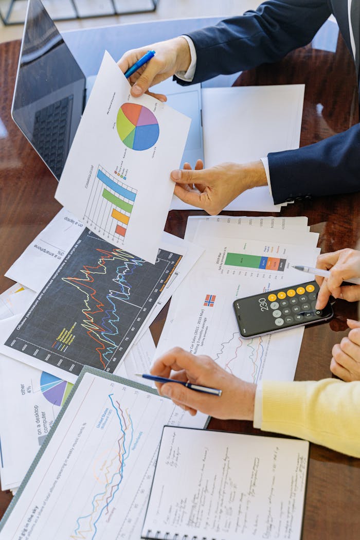 service-03 Business professionals analyzing financial charts and graphs during a meeting.